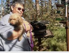 photograph of a woman holding a dog 